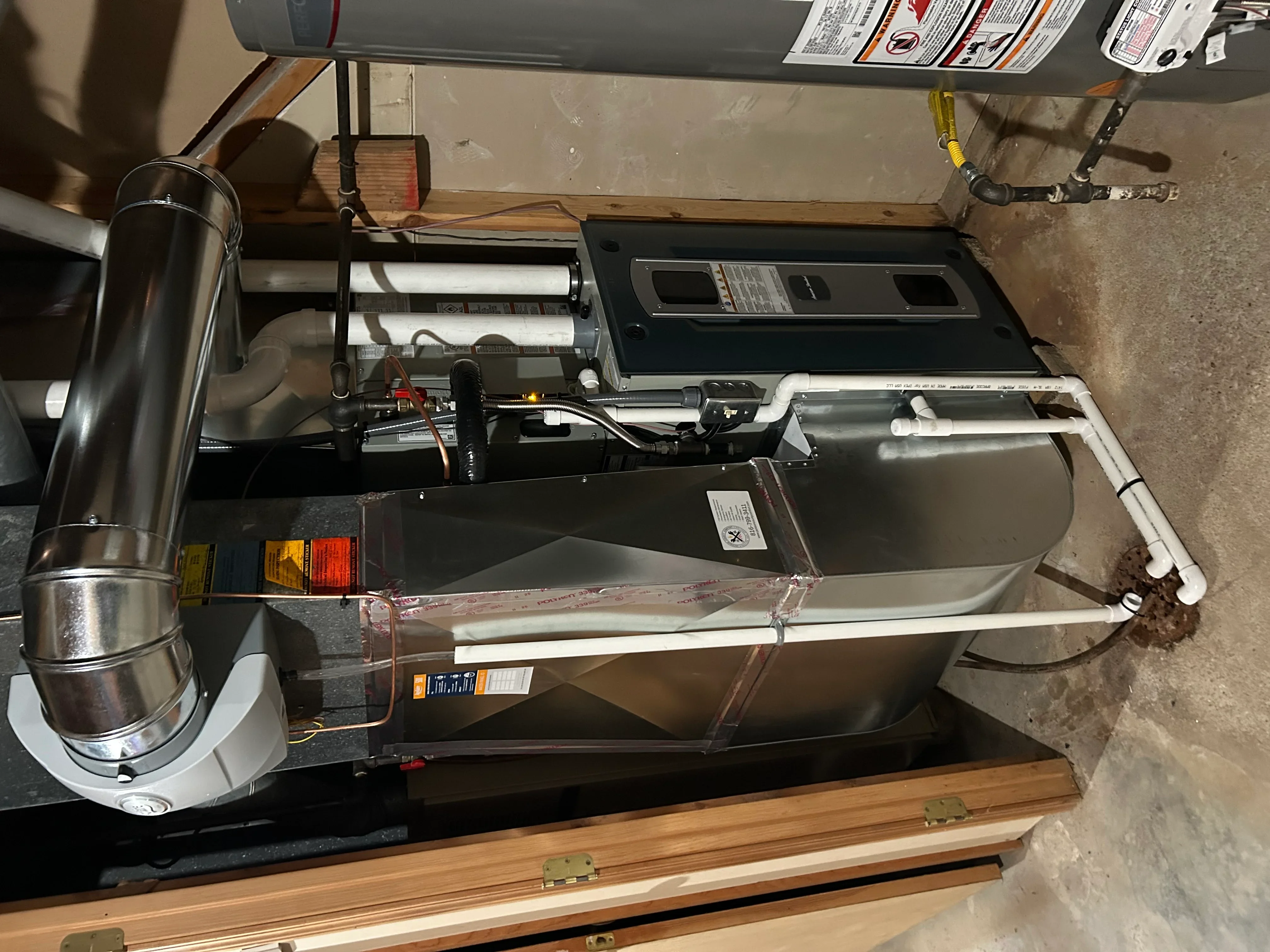 High-efficiency gas furnace with stainless steel vent pipe, electronic controls, and ductwork installation