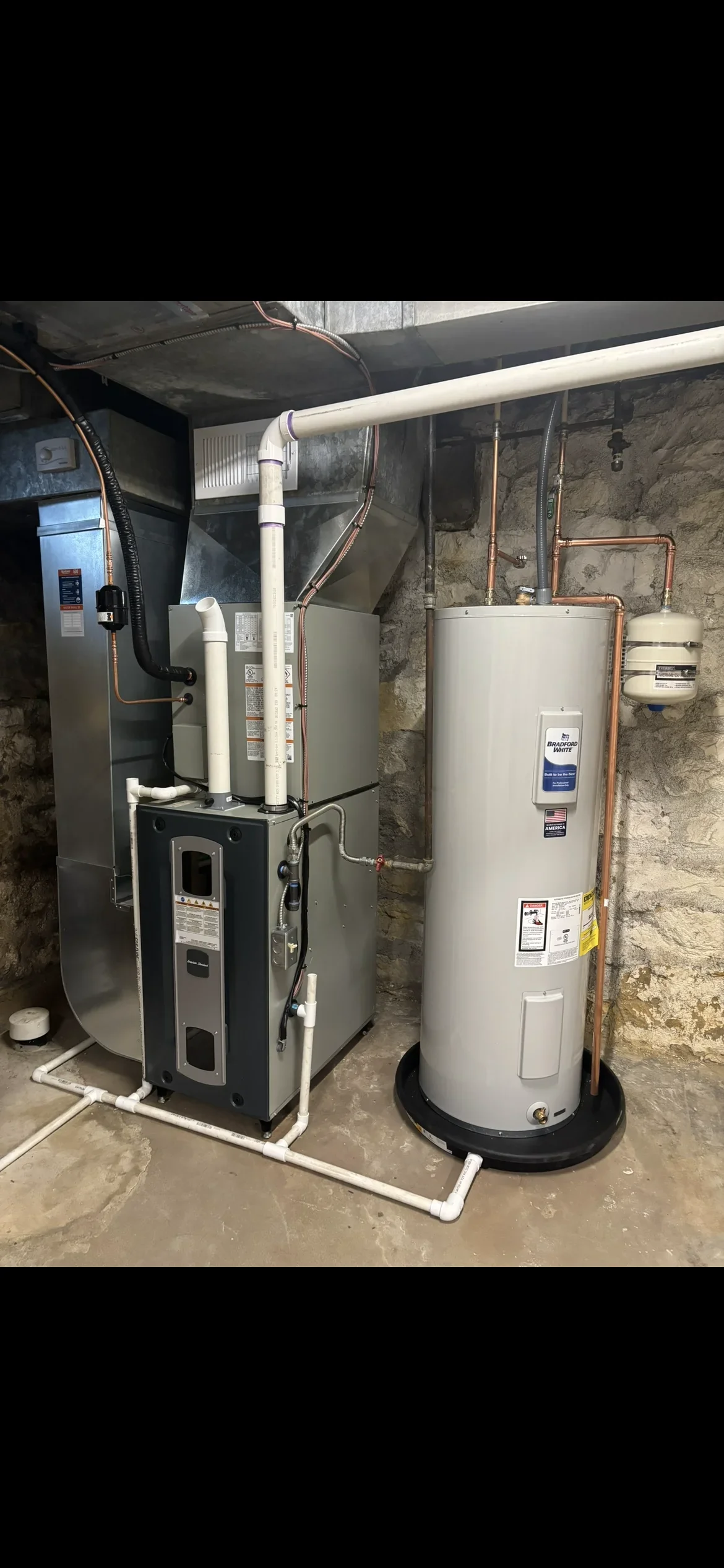 Gas furnace and water heater with copper piping and PVC venting in basement
